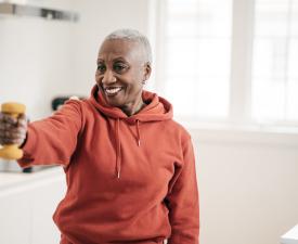 older woman using dumbbells